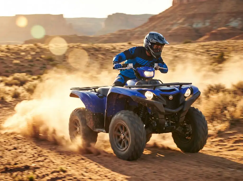 Blue Yamaha Grizzly 350 quad bike kicking up sand in the Dubai desert